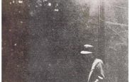 The card shows a man leaning against a lamppost at night in a hazy atmosphere.